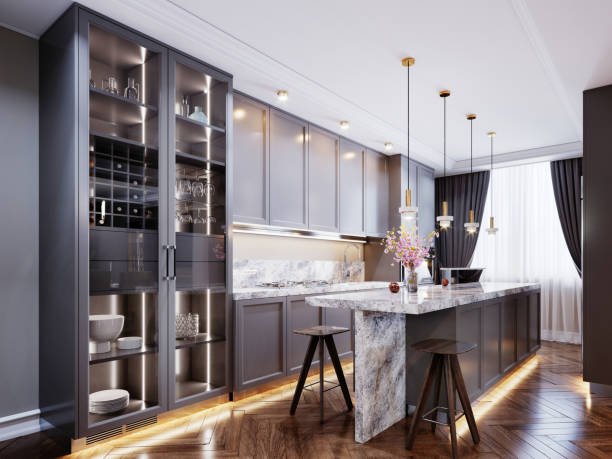 Fashionable modern kitchen with gray contemporary furniture, a kitchen island with a bar counter and two chairs, beige walls and parquet floor. 3D rendering.